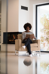 Image showing black woman at home reading book