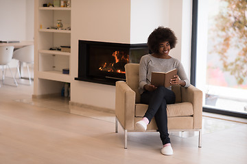 Image showing black woman at home reading book