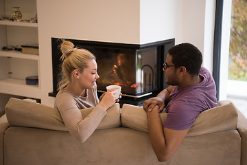 Image showing Young multiethnic couple  in front of fireplace