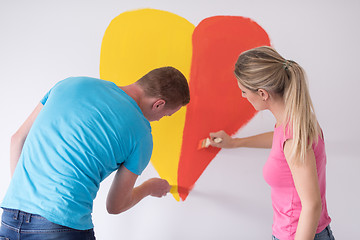 Image showing couple are painting a heart on the wall