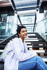 Image showing young cute indian girl at university building sitting on stairs 