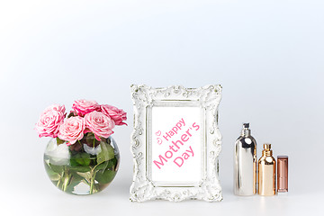 Image showing Flowers vase and vintage frame on white