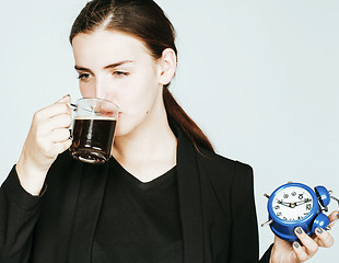 Image showing young beauty woman in business style costume waking up for work 