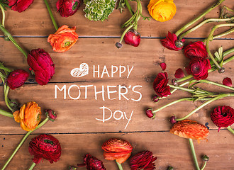 Image showing Ranunkulyus bouquet of red flowers on a wooden background