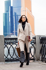 Image showing beautiful business woman in a bright coat