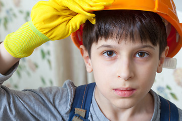 Image showing Boy wearing a protective helmet and gloves