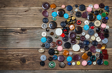 Image showing Old buttons on the wooden boards