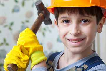 Image showing Boy in the image of a builder with a hammer in his hands