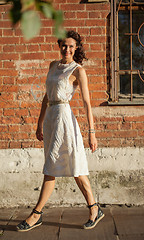 Image showing smiling middle-aged woman in a white dress