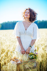 Image showing smiling beautiful woman in white summer dress in a field