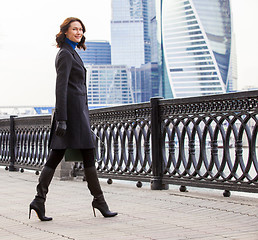 Image showing Smiling handsome entrepreneur in a dark coat