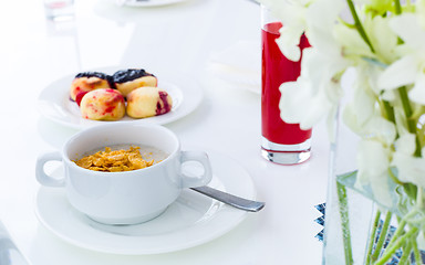 Image showing breakfast. oatmeal and corn flakes