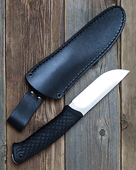 Image showing steel hunting knife near the leather sheath