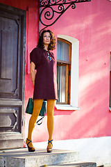 Image showing beautiful smiling middle-aged woman in a burgundy dress