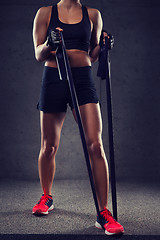 Image showing close up of woman with expander exercising in gym