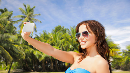 Image showing woman in swimsuit taking selfie with smatphone