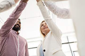 Image showing happy business team making high five at office