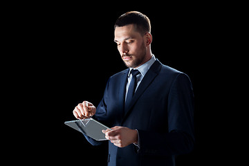 Image showing businessman in suit with transparent tablet pc