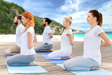 Image showing people making yoga in hero pose outdoors