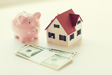 Image showing close up of house model, piggy bank and money