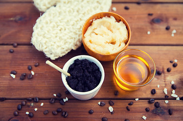 Image showing close up of coffee scrub in cup and honey on wood