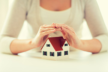 Image showing close up of hands protecting house or home model