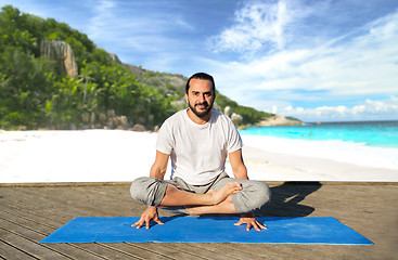 Image showing man making yoga in scale pose outdoors