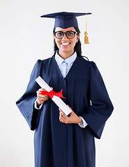 Image showing happy bachelor woman in mortarboard with diplomas