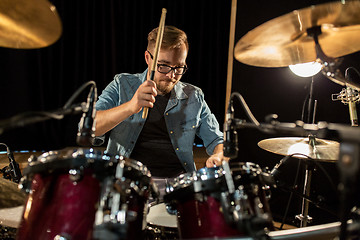 Image showing male musician playing drums and cymbals at concert