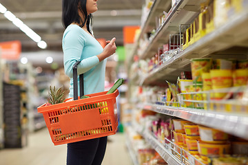 Image showing woman with food basket at grocery or supermarket