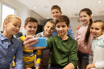 Image showing group of school kids taking selfie with smartphone