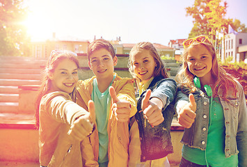 Image showing happy students or friends showing thumbs up