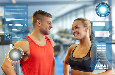 Image showing smiling man and woman talking in gym