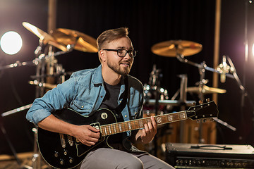 Image showing man playing guitar at studio rehearsal