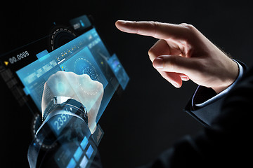 Image showing close up of businessman hands with smartwatch