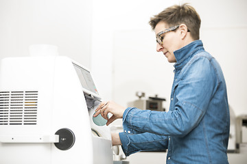 Image showing woman hone the edge of the eyeglasses