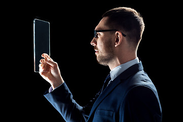 Image showing businessman in suit working with transparent tablet pc