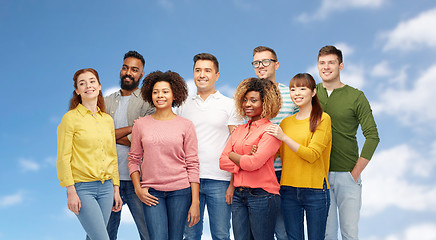 Image showing international group of happy people over blue sky