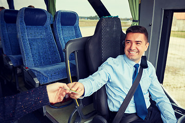 Image showing bus driver taking ticket or card from passenger