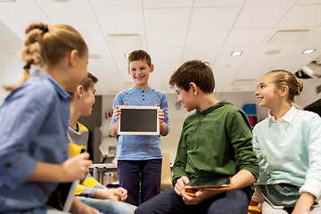 Image showing group of happy children with tablet pc at school