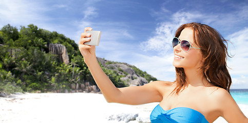 Image showing woman in swimsuit taking selfie with smatphone