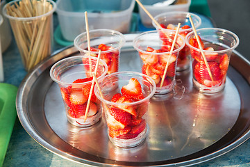 Image showing strawberry in plastic cups at street market