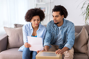 Image showing happy couple with parcel box and paper form home