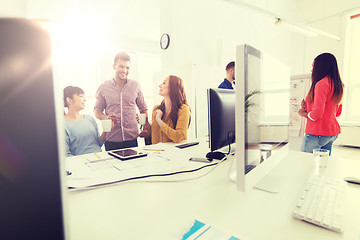 Image showing happy creative team rinking coffee at office