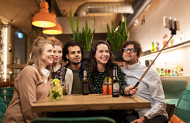 Image showing friends taking selfie by smartphone at bar or cafe