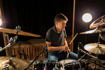 Image showing male musician playing drums and cymbals at concert