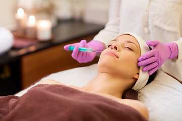 Image showing beautician doing beauty injection to woman lips