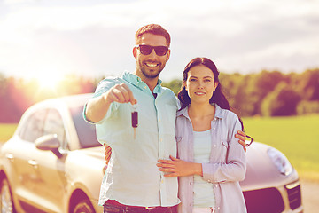 Image showing happy man and woman with car key hugging 