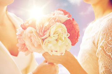 Image showing close up of happy lesbian couple with flowers