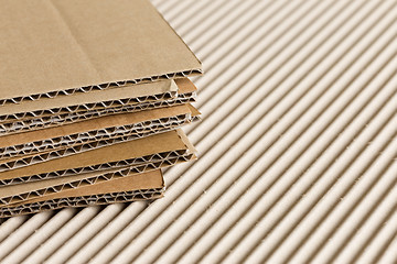 Image showing Cardboard pile on corrugated background